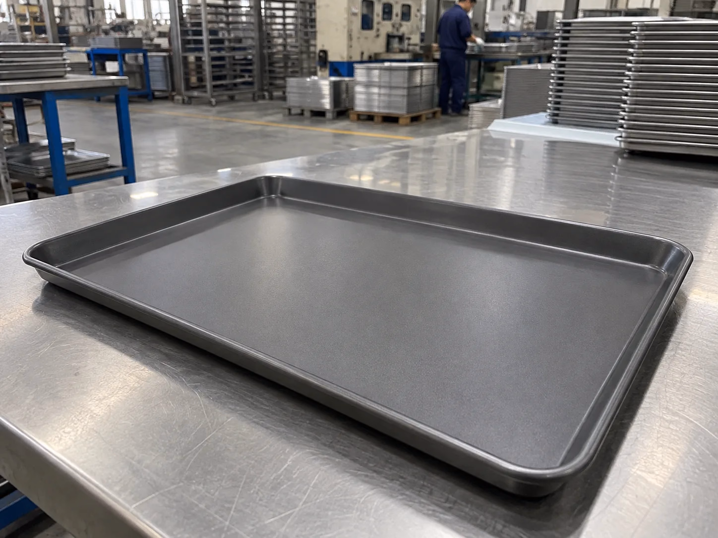 Coated baking tray displayed on a stainless work surface